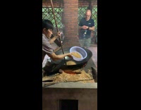 Woman films man cook Vietnam puffed rice