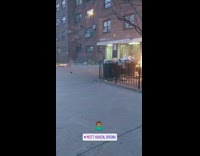 Small fires on sidewalk by building entrance