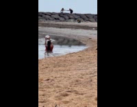 Woman red dress with soccer ball at beach