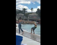 Girl wet jeans pool guy leans back 
