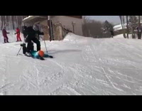 Guy lay slide down mountain between skier