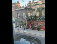 Woman carries a red coat and poses on the doorway