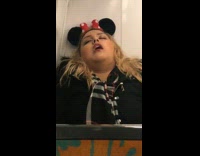 blonde girl in Minnie Mouse ears asleep in back of train