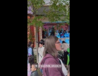 People gather along the street outside house for halloween NYC 
