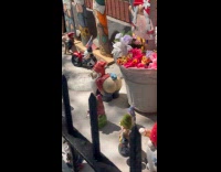 Gnome decoration with butt out outside apartment