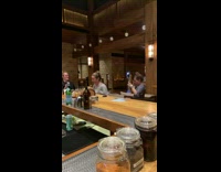 Two women dance tiktok clap inside bar