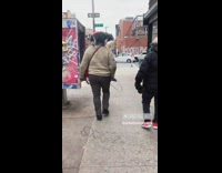Black Dog Balances on Pet Owners Shoulders while Walking 