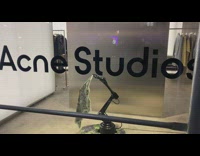 Robot waves bandana inside fashion store 