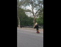 Two men in bald eagle helmet and American flag costume ride through park on motorized skateboards