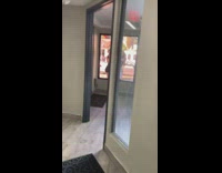 Two girls take selfie outside tinted window