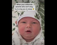 Baby being held and filmed looks around confused