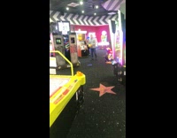 Guy throws yellow ball basketball hoop arcade 
