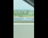 Guy flies in air using water jetpack hydroflight in lake