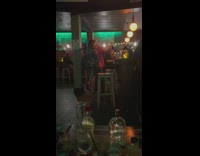 Woman in shiny dress dances inside the bar