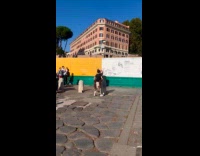Couple romantic kiss pose near the colosseum