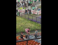 Woman in Pink Dress with matching 23 balloons poses at concert