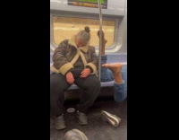 Feet of man near woman sleep in train