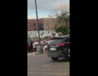 Protesters poses with their signages at the parking lot