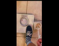 Guy steps on scale and moves toilet brush like hes driving 