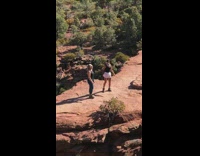 Two girls jump pose rock people watch 