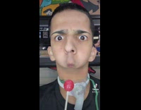 Guy with small mouth licks lollipop 