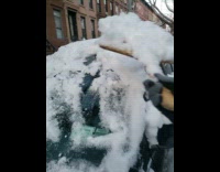 Guy shovels snow off of car with pizza paddle 