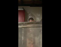 Guy washes dishes scared by things thrown at him runs out of garage