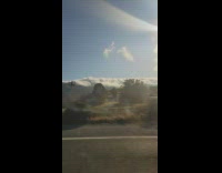 Car ride view clouds roll over mountains