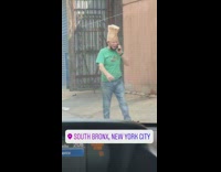 Man on phone with paper bag on head