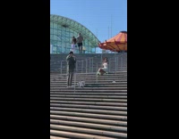 Woman white dress polka dots roller blades stairs