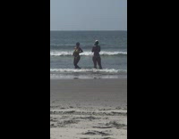 Woman in yellow bikini poses at the beach