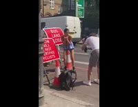 Girl ducks red bus lane closed sign 