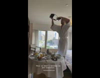 Guy stands on hotel bed to take food photo 