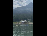 Girl fail bend over pose surfboard lake 