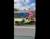 Slingshot car driver with mask and flag