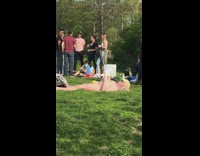 Naked Man Sunbathes and Reads Book at Park 