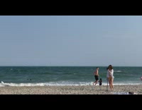 Woman tripod fell because of wind beach