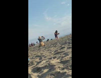 Woman black swimsuit pickup sand beach