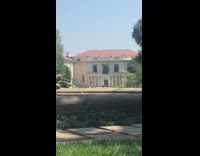 Grey dress girl dances outside water fountain