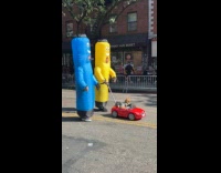 Couple inflatable tube man costume parading with dog 