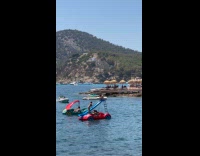 Woman poses on slide on vehicle boat