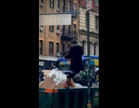 Collab WINY - Man on dumpster hold tripod like rifle