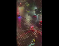Fire truck pulls up next to flooded street car