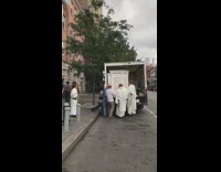 Priest and altar servers move pulpit 