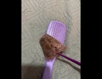 Woman removes pile of hair from brush