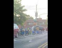 Guy pedals on parked bike 