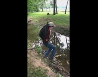Collab Clips mpugc - Guy with backpack on rope tied to tree falls into creek water