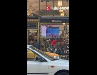 Guy riding indoor exercise bicycle in the storefront of Lululemon Soulcycle