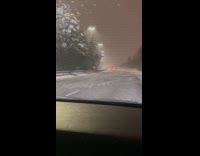 Snowy road with visible air on pavement