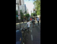 Crowd of skaters ride down the street together